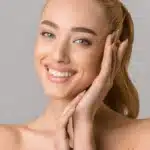 beautiful smiling-woman touching her face