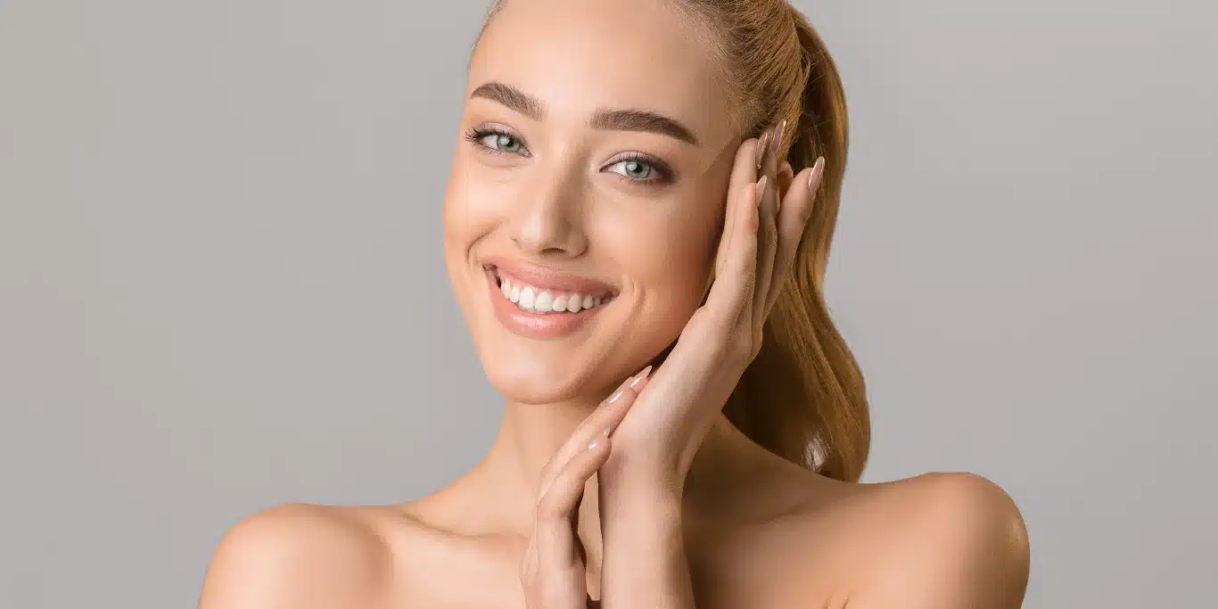 beautiful smiling-woman touching her face
