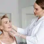 cosmetologist client face examination